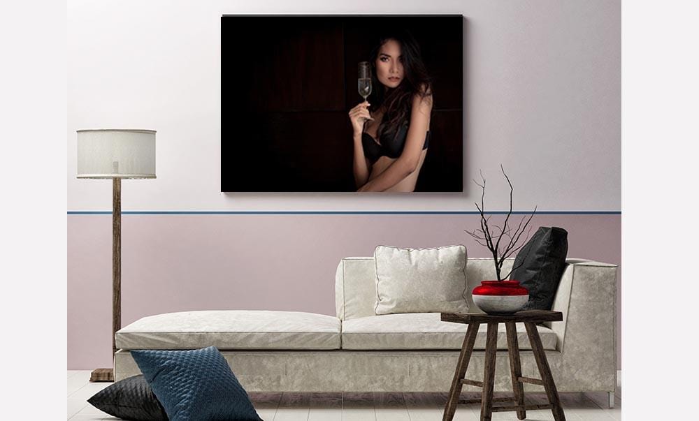 Woman wearing bra holding champagne glass