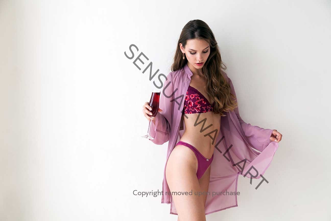 Young woman in panties and  silk shirt holding wine glass