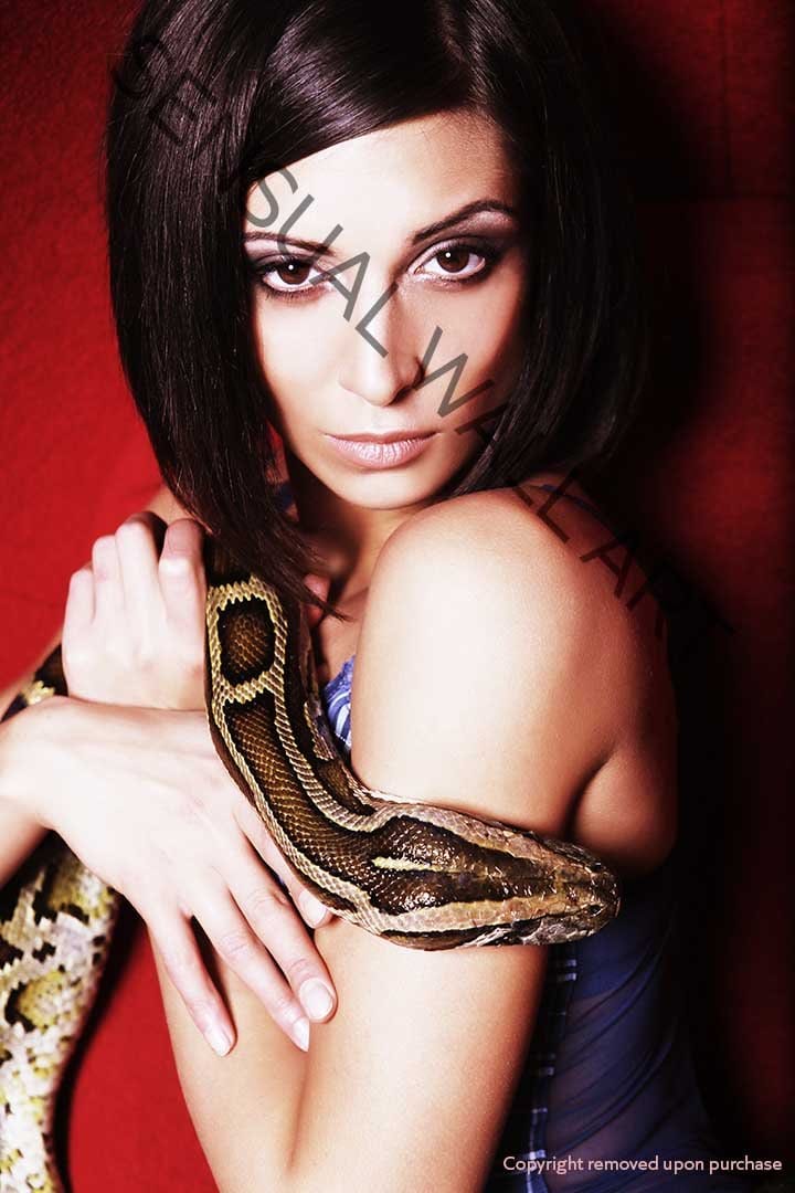 gorgeous brunette woman holding a python