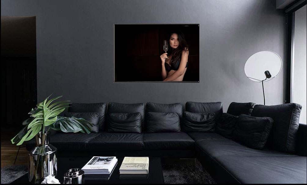 Woman wearing bra holding champagne glass