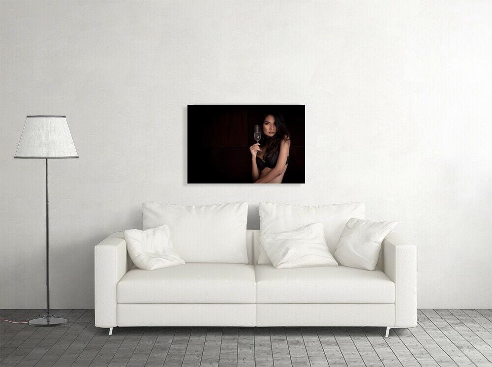 Woman wearing bra holding champagne glass